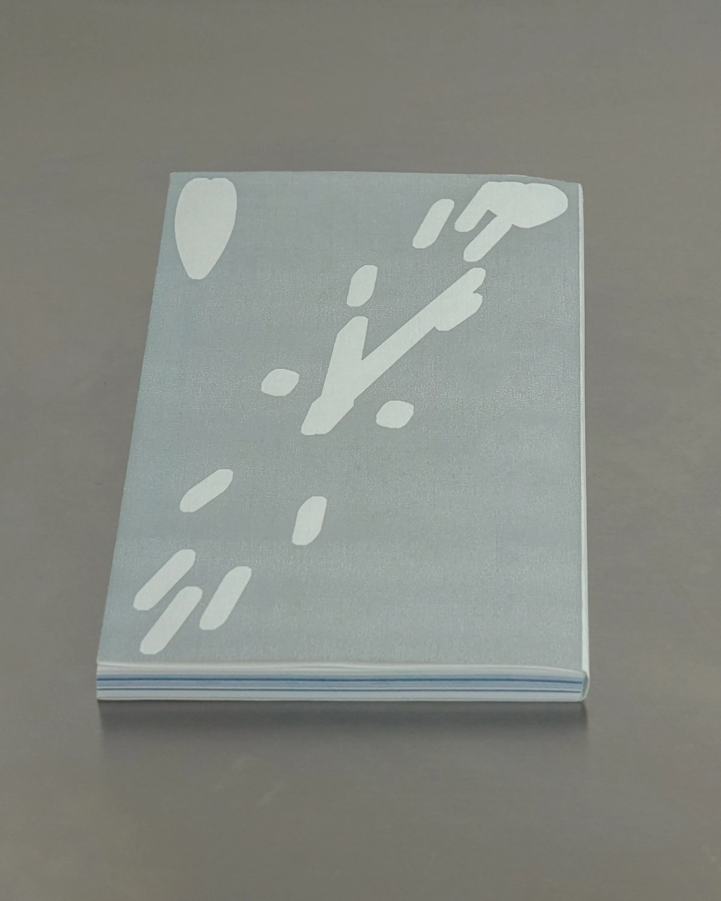 Back cover featuring an abstract clock and two hearts in white on a silver background.