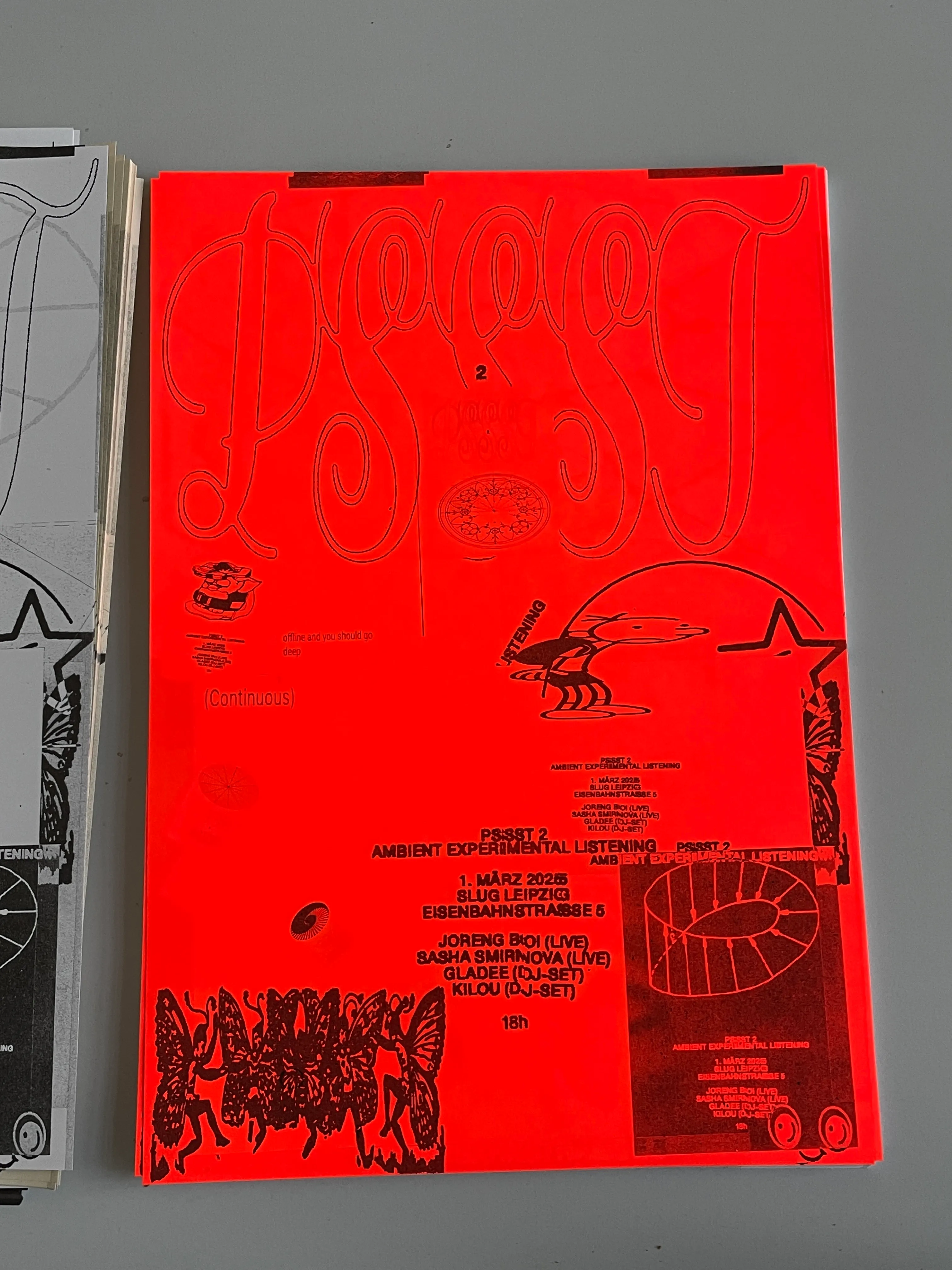 Riso-printed posters on bright red paper.