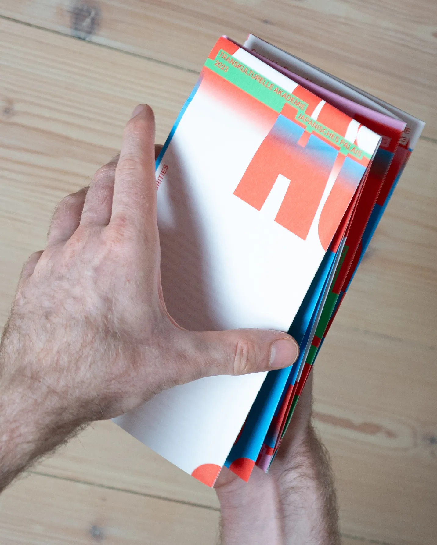 Close-up of a person holding the folded flyer